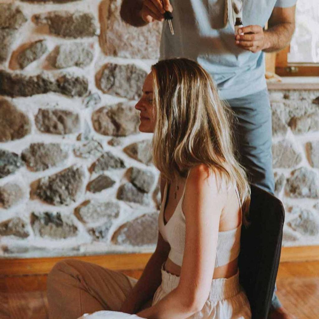 omprakash putting flower essences on a head of a woman